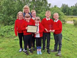 From left to right: -
Grace Sheppard aged 8, Bethany Sheppard aged 7,
Mason Bogg aged 7, Daisy Couzens aged 6, Arley Mehmet aged 10 and Brodie Trollope aged 9. 
Behind Sue Feary eco committee lead at the school